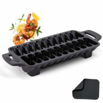 Cast iron cornbread pan with shrimp garnish.