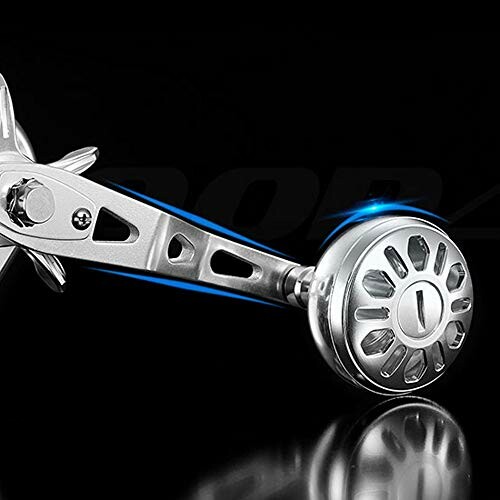 Close-up of a fishing reel handle on a black background