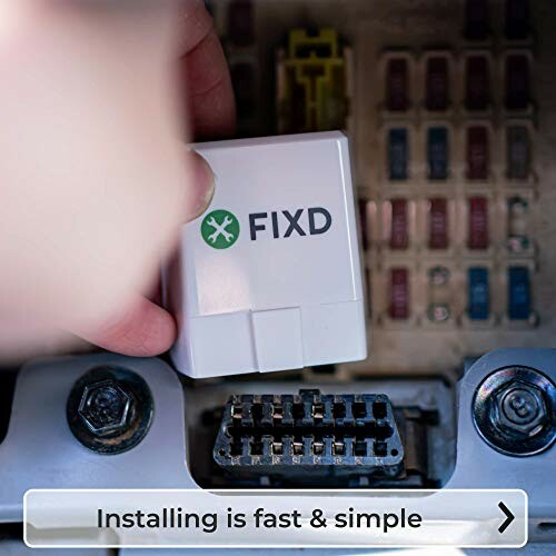 Hand installing FIXD device in car diagnostic port