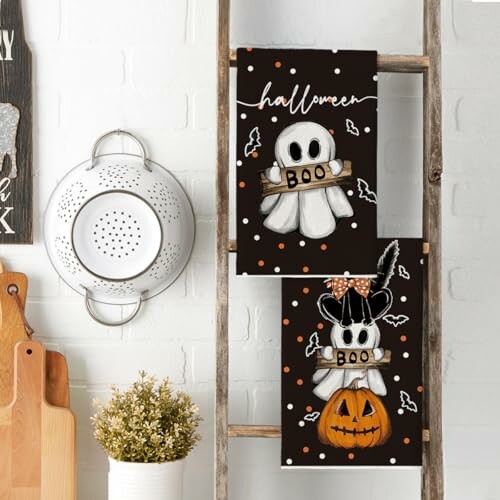 Halloween-themed kitchen towels with ghost and pumpkin designs.