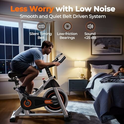 Man using a quiet belt-driven exercise bike in a bedroom while a child sleeps in the background.