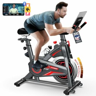 Man using an indoor exercise bike with a tablet holder and Bluetooth connectivity.