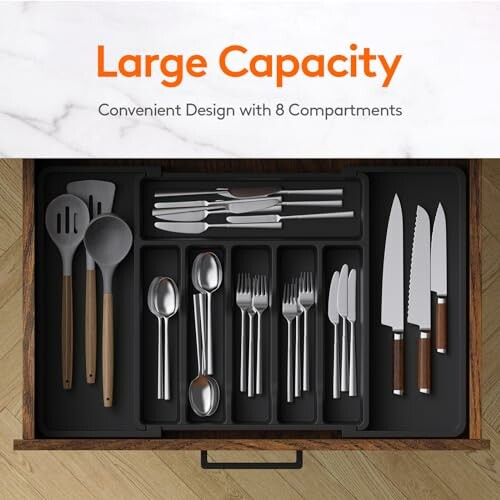 Drawer organizer with large capacity and 8 compartments holding kitchen utensils.