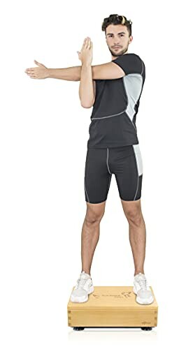 Man performing a standing stretch on a wooden platform