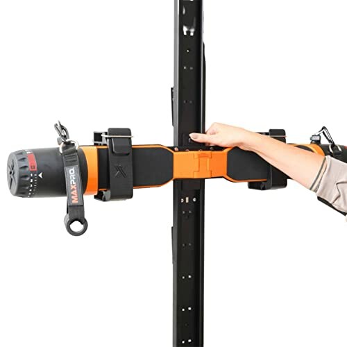 Person adjusting a portable electric hoist mounted on a vertical beam.