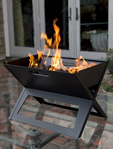 Portable fire pit with flames on a patio