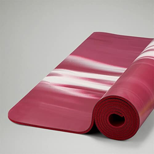 Red rolled yoga mat with white patterns