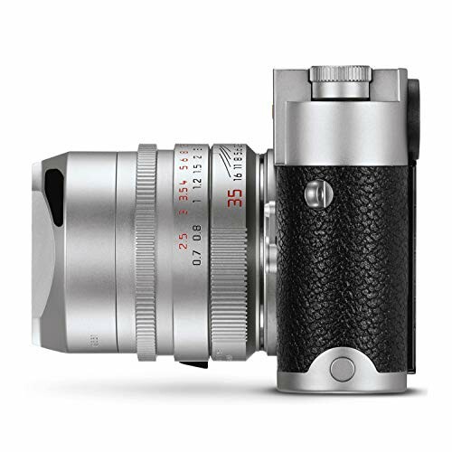 Side view of a silver vintage camera with a textured grip and lens