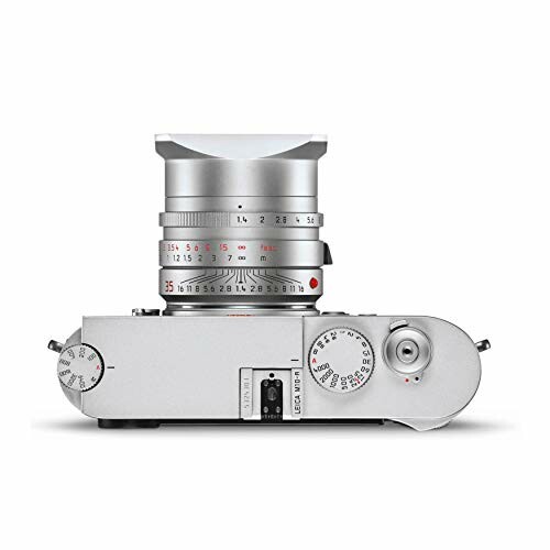 Top view of a silver vintage camera with lens and dials