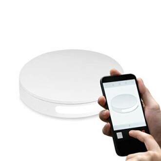 Smart scale with a person holding a phone app.