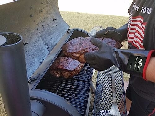 Person grilling meat in a smoker with gloves