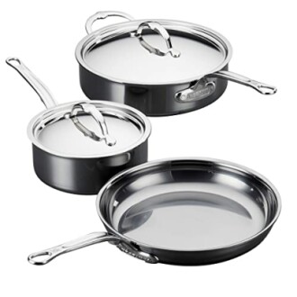 Stainless steel cookware set with lids and handles.