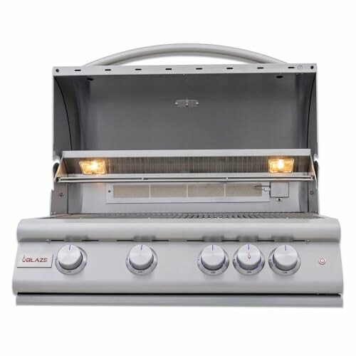 Stainless steel gas grill with open hood and control knobs