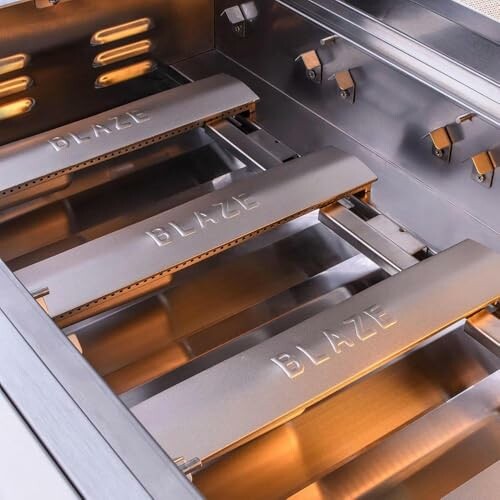 Stainless steel grill burners with Blaze branding.