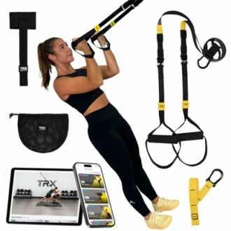 Woman using TRX suspension trainer with accessories including straps, bag, and mobile app display.
