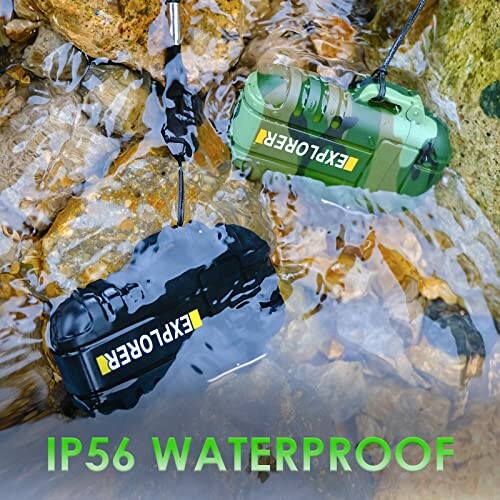 Two waterproof speakers submerged in water among rocks.