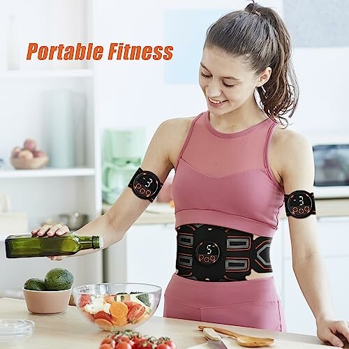 Woman wearing a portable fitness device in kitchen.