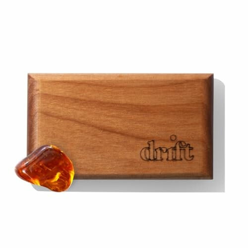 Wooden block with amber stone and 'drift' engraving.