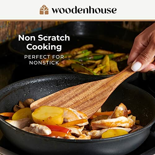 Wooden spatula stirring vegetables in nonstick pan.